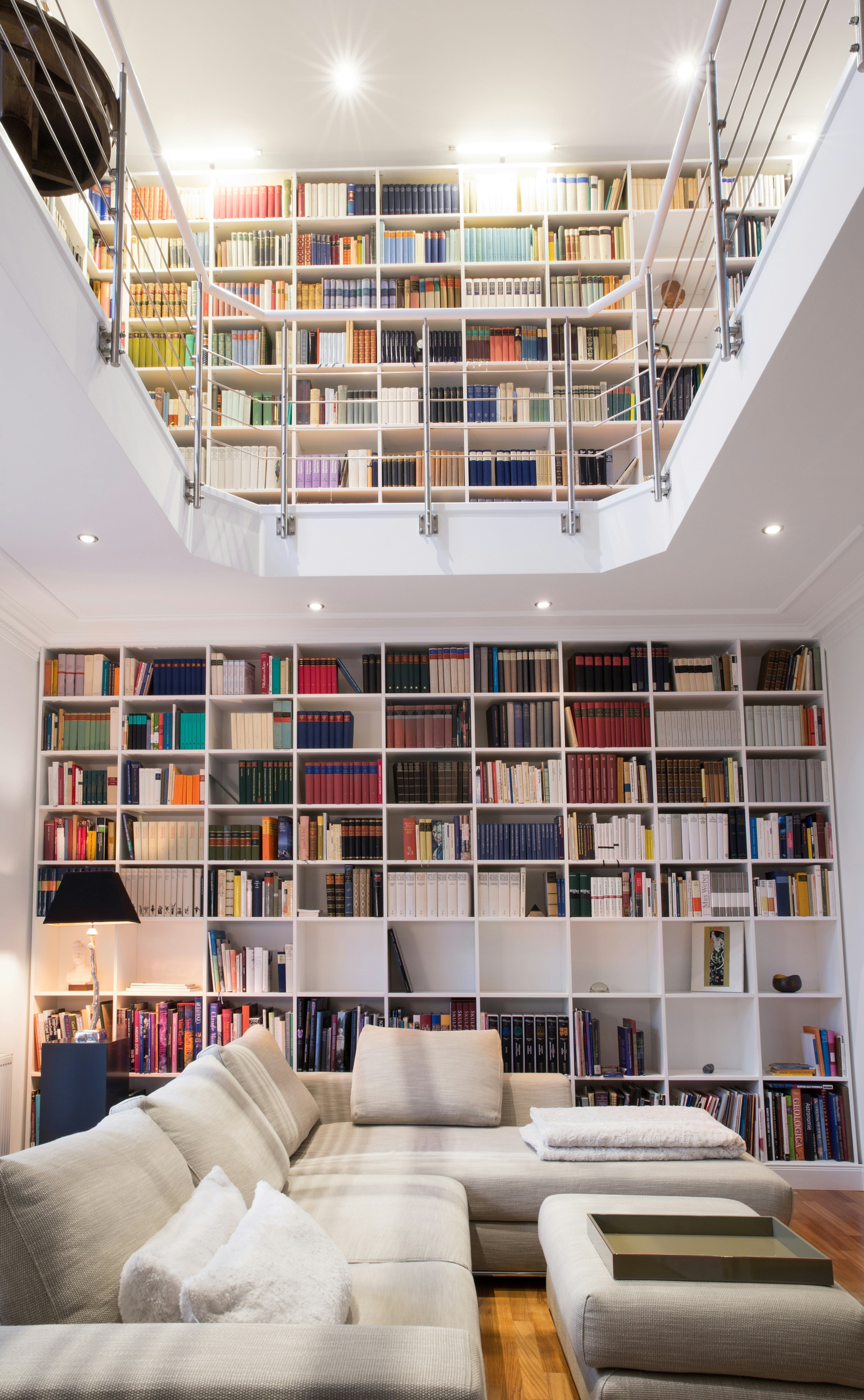 Elegant home library with shelves and cozy seating from Homepressions.com.