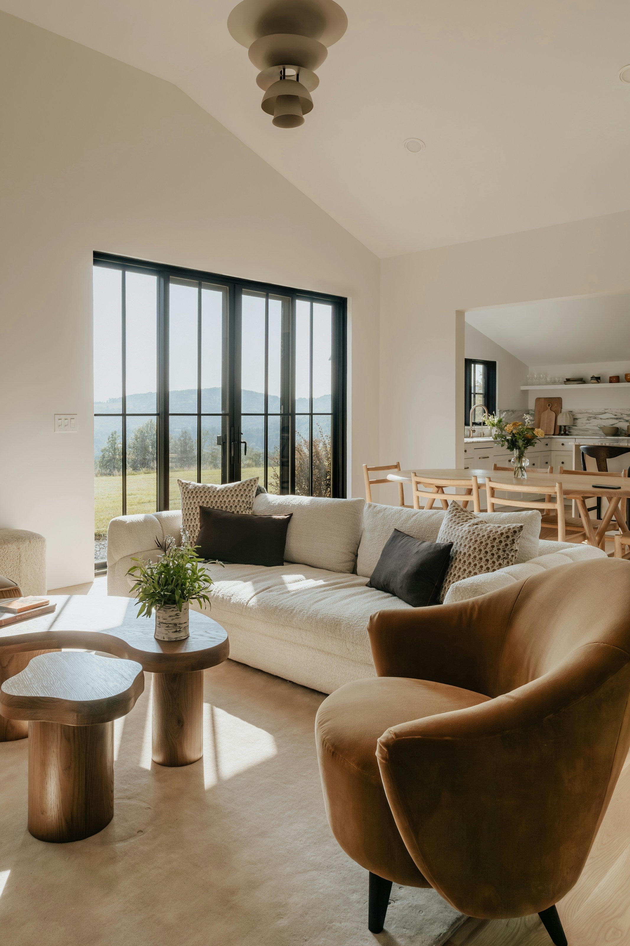 Luxurious living room with velvet seating and sculptural accents by Homepressions.com.